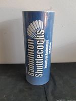 Front view of blue tube labelled Badminton Shuttlecocks