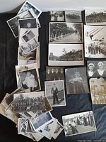Overview of spread of vintage photographs on black surface