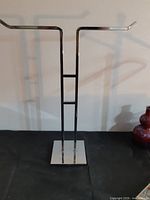Full front view of chrome necklace stand
