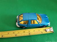 Top view showing full car and measuring tape for size reference