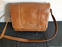 Front view of caramel faux-leather purse with Opal logo and adjustable strap