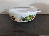 Side view of bowl with lid showing vegetable motif