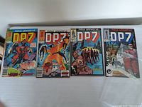 Four D.P.7 comics laid side by side showing front covers