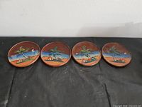 Four wooden coasters in a row, front view