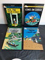 Group shot of four Tintin laminated plaques