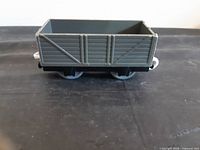 Side view of grey plank-sided cargo wagon