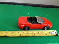 Left side view with measuring tape showing ~3 in length