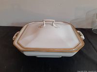 Top view of lidded casserole dish with gold trim