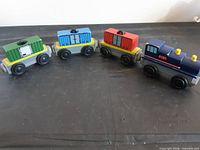 All four wooden train cars lined horizontally