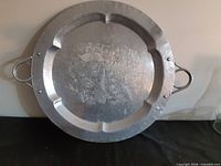 Full view of round Lehman aluminum platter showing embossed design and handles