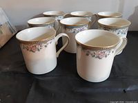 Group of eight matching Lenox Spring Vista mugs showing floral band and gold trim