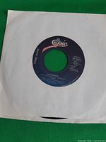 Record in white sleeve showing A-side label