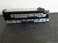 Left side view of black and silver New York Central diesel locomotive model