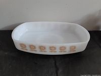 Full view of white milk glass rectangular dish showing brown floral motif