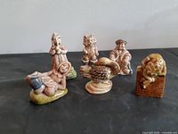 Group shot of five Wade Nursery Rhyme figurines on tabletop