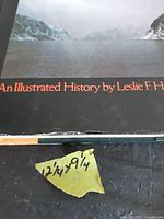 Close-up of dust jacket edge wear and taped size note