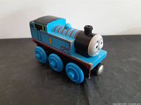 Left side view of wooden Thomas engine showing number 1 and wear