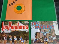 Three 7-inch records: one CBS in orange sleeve, two Los Panderos picture sleeves