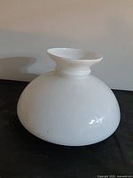 side view of white opal glass lamp shade showing rounded body and flared top