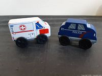 Ambulance and police car side view showing graphics and wheels