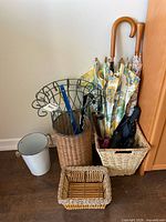 Group shot showing wicker umbrella stand, metal rack, baskets, umbrellas and bucket
