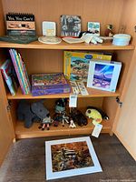 Full view of shelves showing books, puzzles, plush toys and décor
