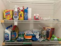 Both wire shelves showing entire assortment of cleaning products, hardware items and green dumbbells