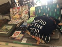 overview of assorted placemats, trays, aprons stacked on countertop