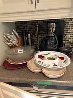 Overall view showing coffee maker, knife block, frosted bowl, platters, mill