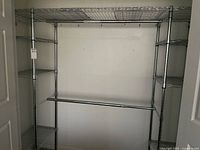Full view of chrome wire shelving unit in closet space