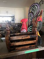Wooden rooster magazine rack with metal wire and large painted rooster visible