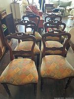 Front view showing all six carved wood dining chairs
