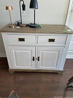 Front view of cabinet showing drawers, doors, hardware, fluted sides