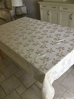 Tablecloth spread on dining table showing full size and pattern