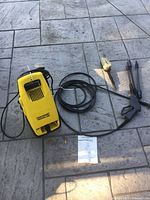 Front and top view of Craftsman pressure washer with hose, gun, wands, brush and manual visible