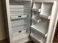 Open door showing interior shelves, baskets and door bins