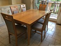 Dining table with four of eight chairs in non-extended configuration