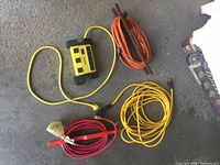 Overview of four extension cords and power bar on floor