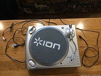 Top view of ION Audio LPDock turntable with felt mat and attached cables