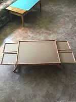 Full view of folding puzzle table with drawers partially extended