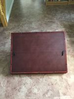 wooden cover with handles attached to puzzle table