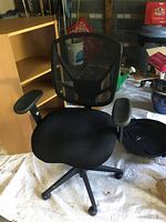 Front view showing mesh back, armrests, seat, base with casters