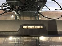 Top view of soundbar showing control buttons and cable