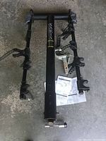 Full view of Saris rack upright with arms folded, hardware and instructions visible