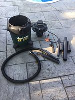 vacuum canister, motor lid, hose, wands and attachments displayed