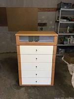 Front view showing six drawers, frosted glass top drawer, cream lower drawers, beech frame