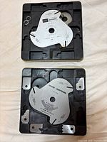 Two Craftsman dado blades in plastic cases with metal spacers visible