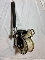 Overall view of hand winch showing handle, frame, gear and strap