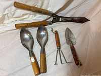All five garden tools laid out