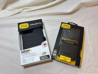 Front view of both boxed OtterBox cases